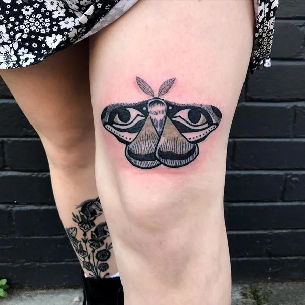 Butterfly above knee tattoo