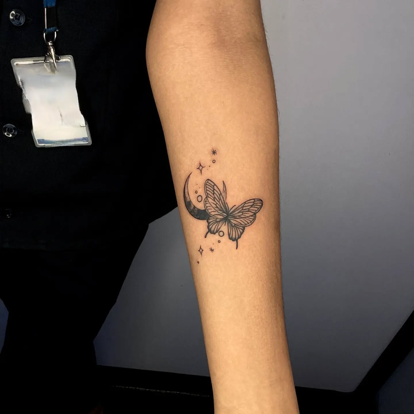 Butterfly and crescent moon tattoo on forearm symbolism