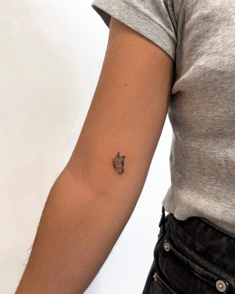 Butterfly flying side view on the elbow, detailed wings for a subtle beauty: fluttering elegance