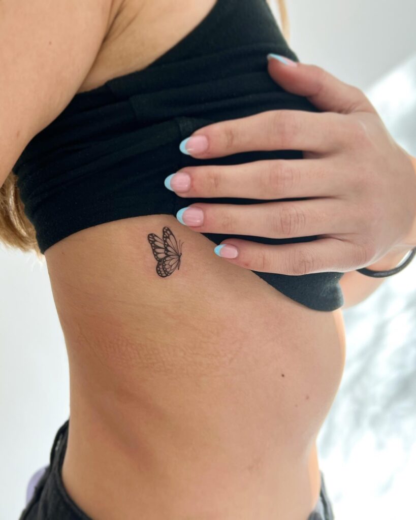 Butterfly flying side view on the rib, intricate wings and details in a petite design: aerial ballet