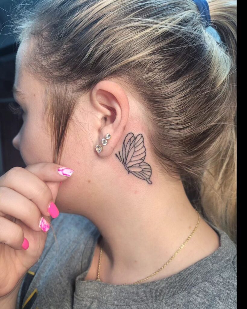 Butterfly outline tattoo behind the ear girl graceful minimalism