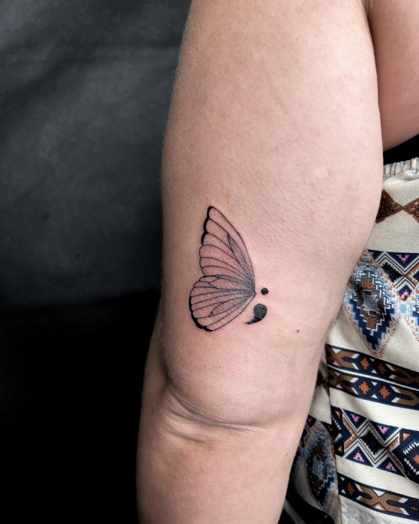 Butterfly Semicolon Tattoo Above the Outer Elbow: Illustrative Flight