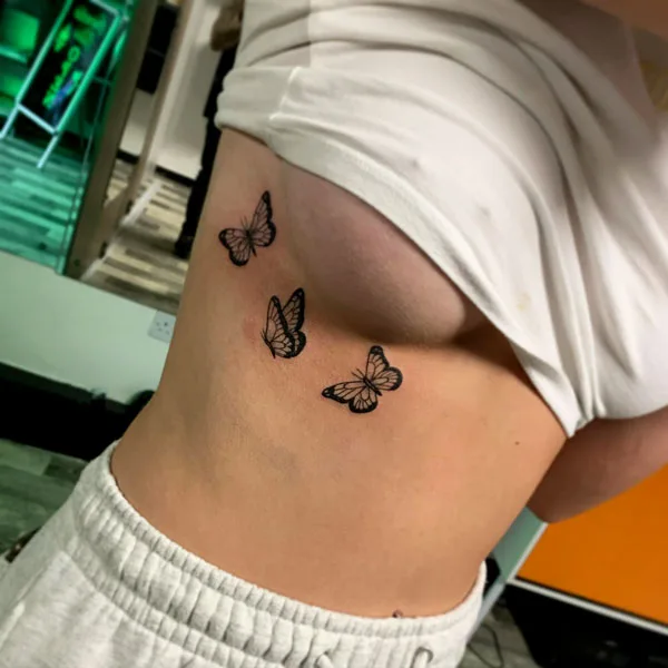Butterfly side boob tattoo