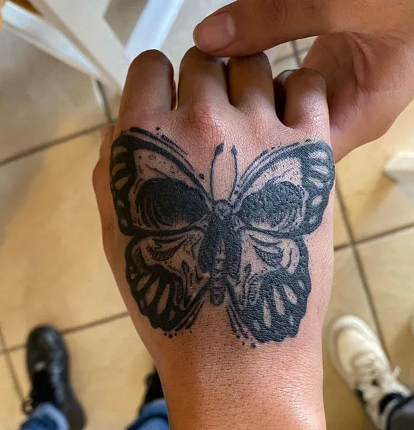 Butterfly skull hand tattoo