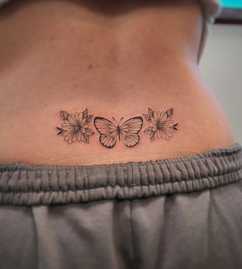 Butterfly Surrounded by Floral Lower Back Tattoo: Blooming Radiance