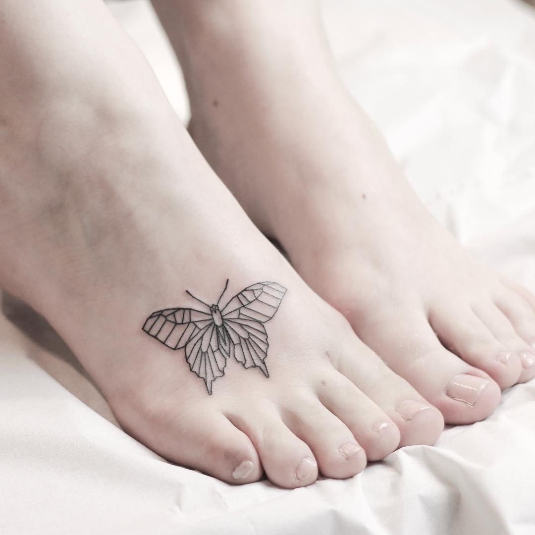 Butterfly tattoo on top of foot symbolizing journey and transformation