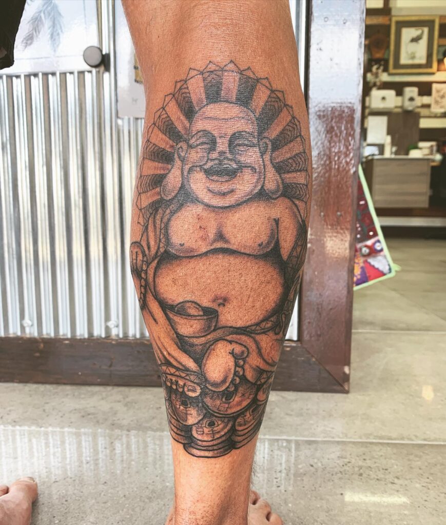 Calf Tattoo Featuring Strong Outlines of the Laughing Buddha: Bold Serenity 