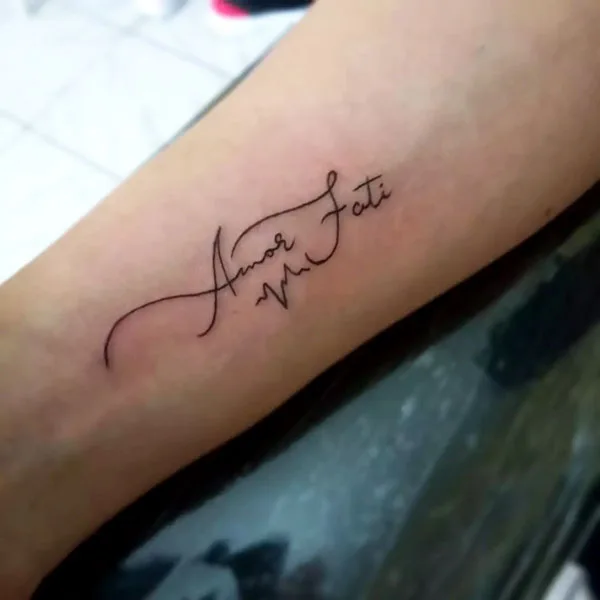 Calligraphy amor fati tattoo