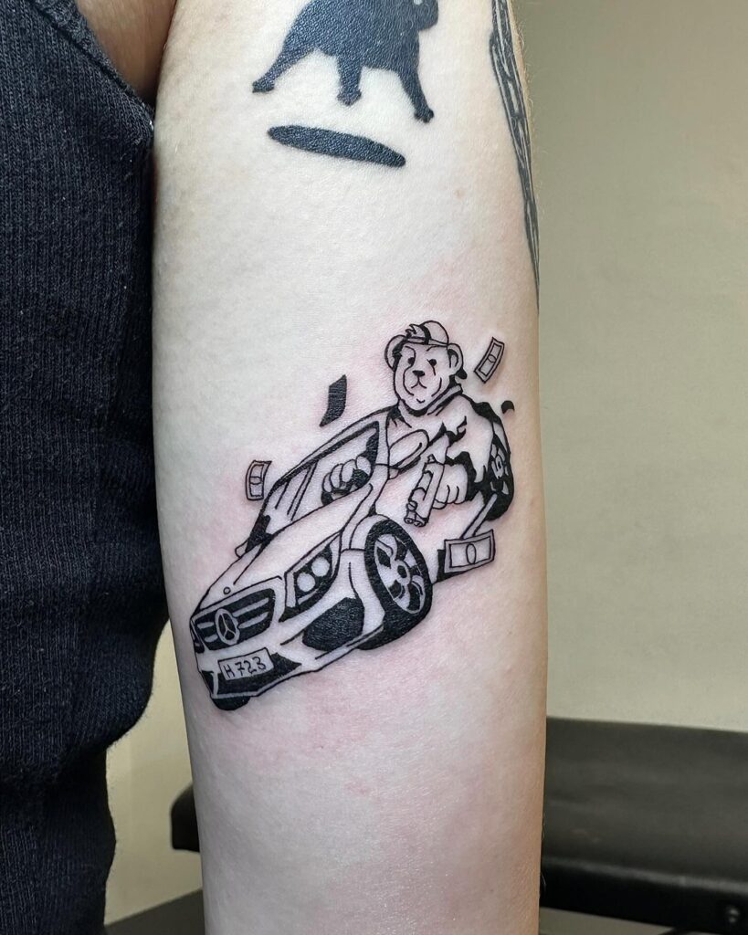 Cartoonish Gangster Bear in a Mercedes-Benz Tattoo with Bold Linework on Arm – Car Tattoo Ideas