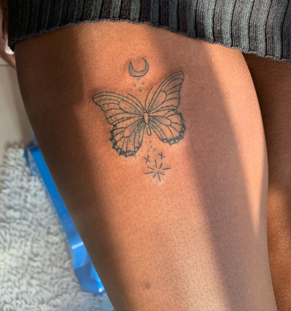 Celestial charm minimalist butterfly sun and moon tattoo on thigh for women