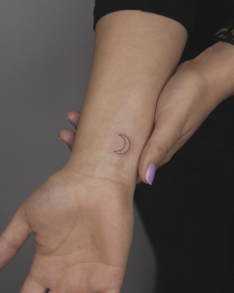 Celestial whispers feminine small outline moon tattoo on the wrist