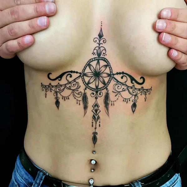 Chandelier under breast tattoo