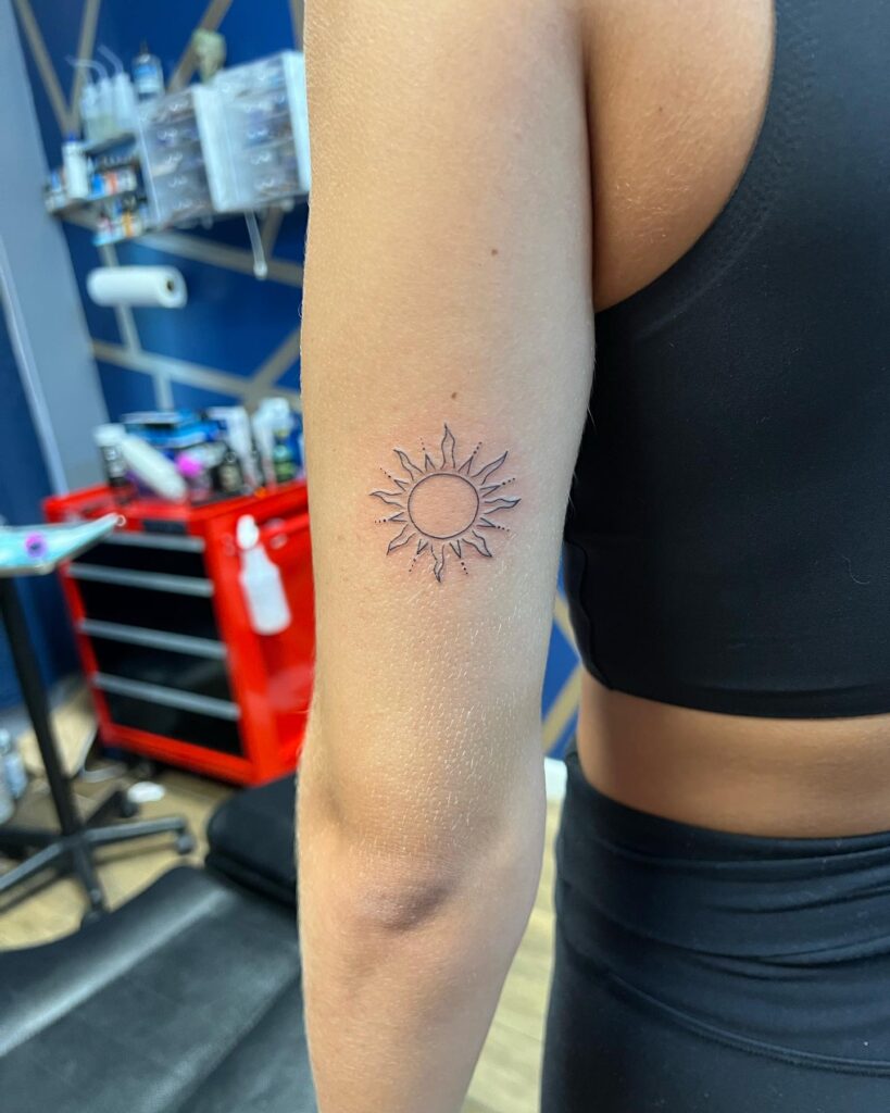 Chasing the sun back of the arm sun tattoo