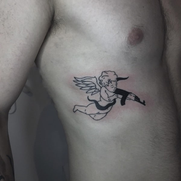 Chest area black and white angel with gun tattoo