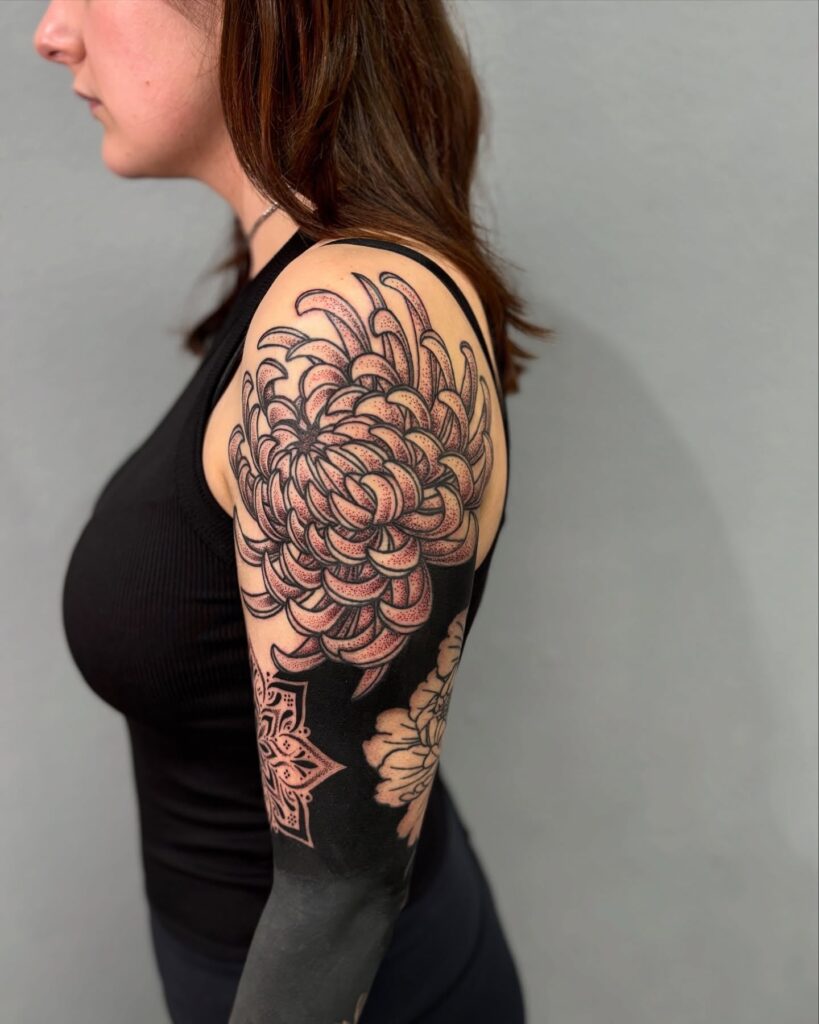 Chrysanthemum tattoo sleeve with dotwork and blackwork contrast