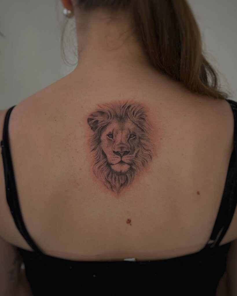 Classic lion face tattoo on the back for women: gorgeous back majesty