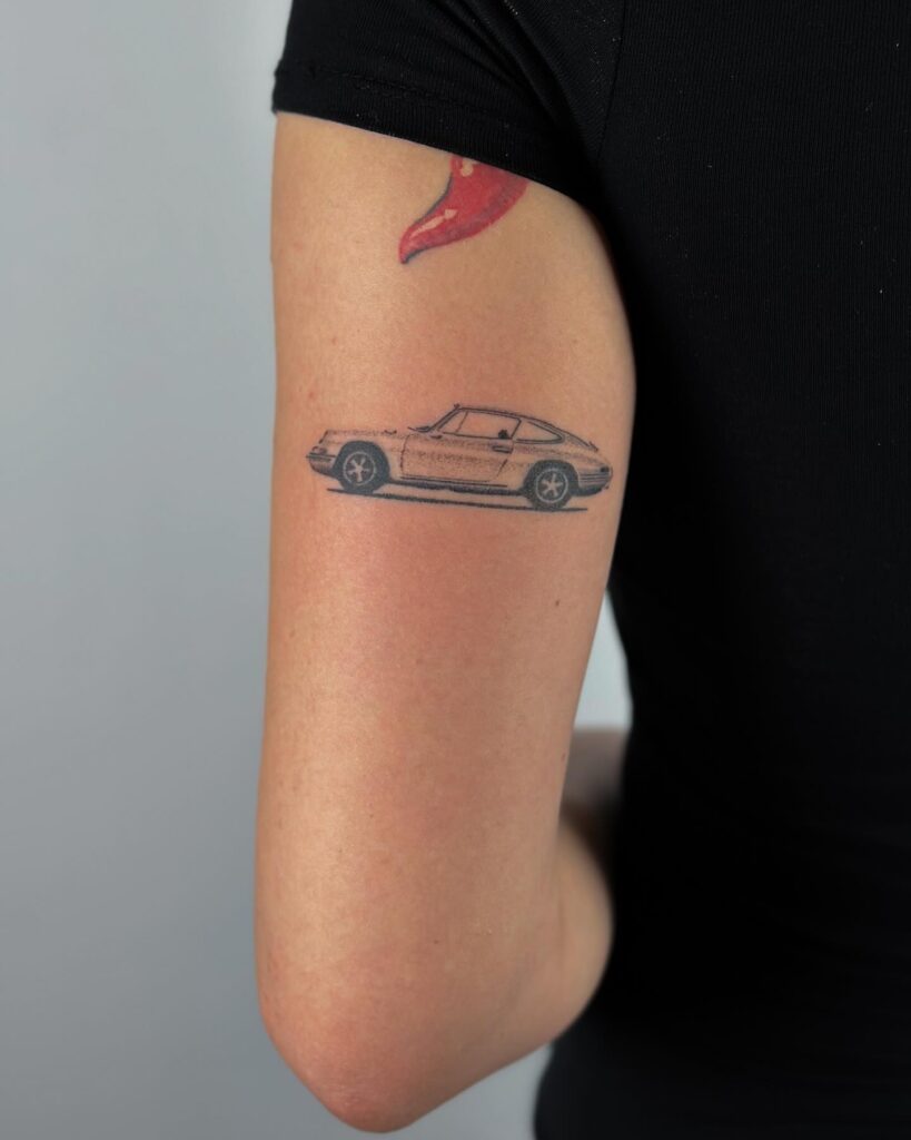 Classic Porsche 911 Tattoo on Outer Upper Arm, Showcasing a Passion for Sports Cars – Car Tattoo Ideas