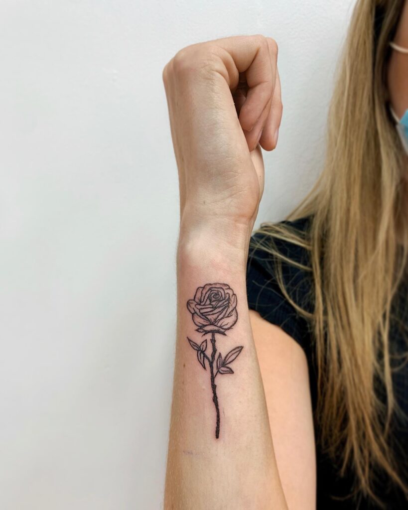 Classic rose flower tattoo on the side wrist for girls, a symbol of beauty and romance: timeless elegance