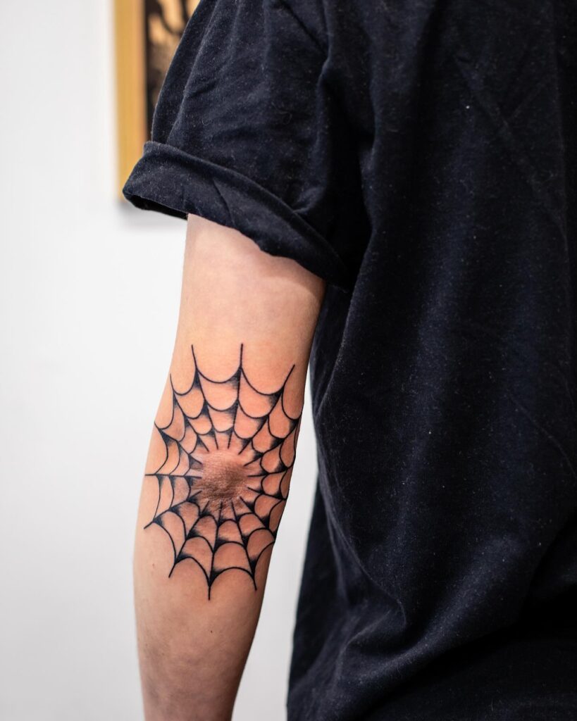 Classic Spider Web Tattoo on the Back of the Elbow: Intricate Connection
