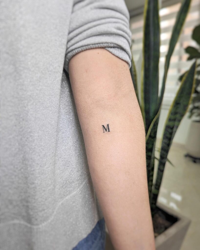 Classy 'M' Letter Tattoo: Forearm Adornment