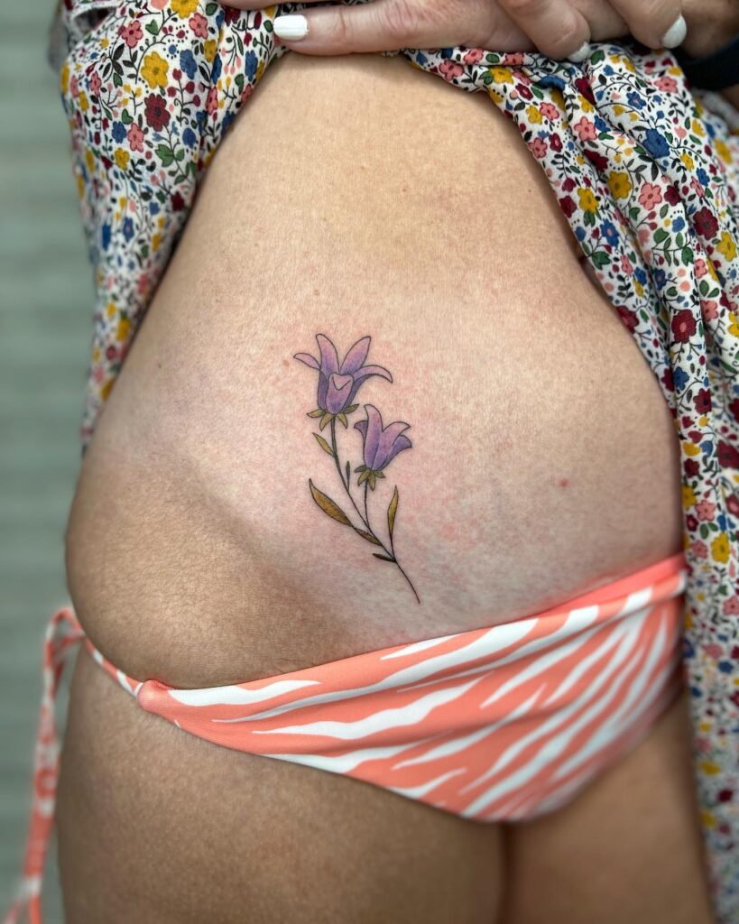 Classy Side Stomach Bluebell Flower Tattoo for a Small, Clean, and Colorful Touch: Stomach Blossoms