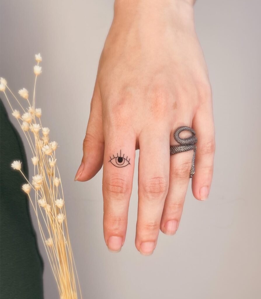 Clean and Small Cute Eye Tattoo on the Outer Index Finger: Tiny Visionary
