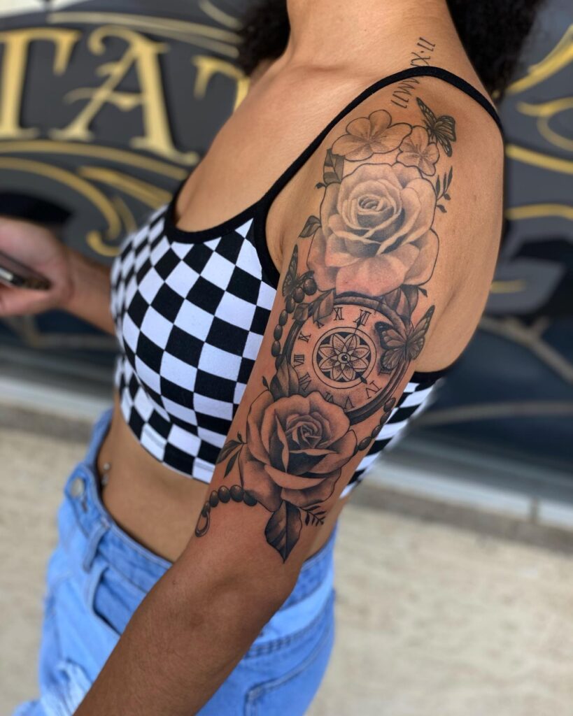 Clock and roses an upper half sleeve tattoo with flower charm