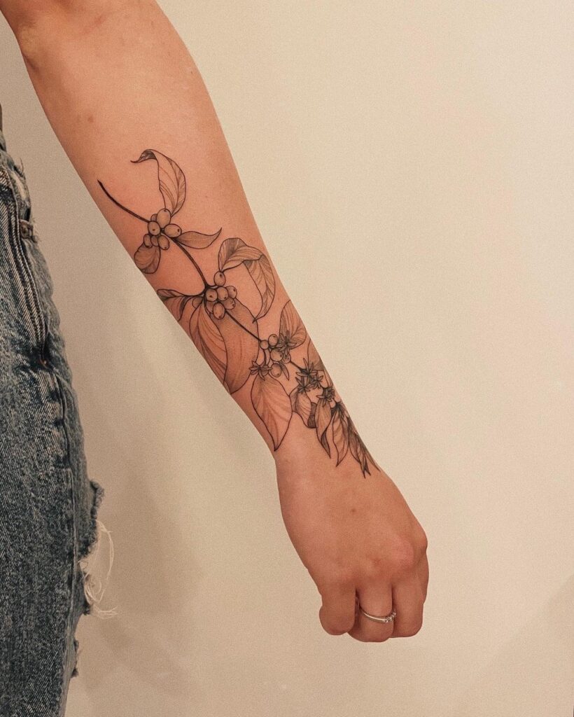 Coffee plant forearm wrap tattoo for women organic elegance