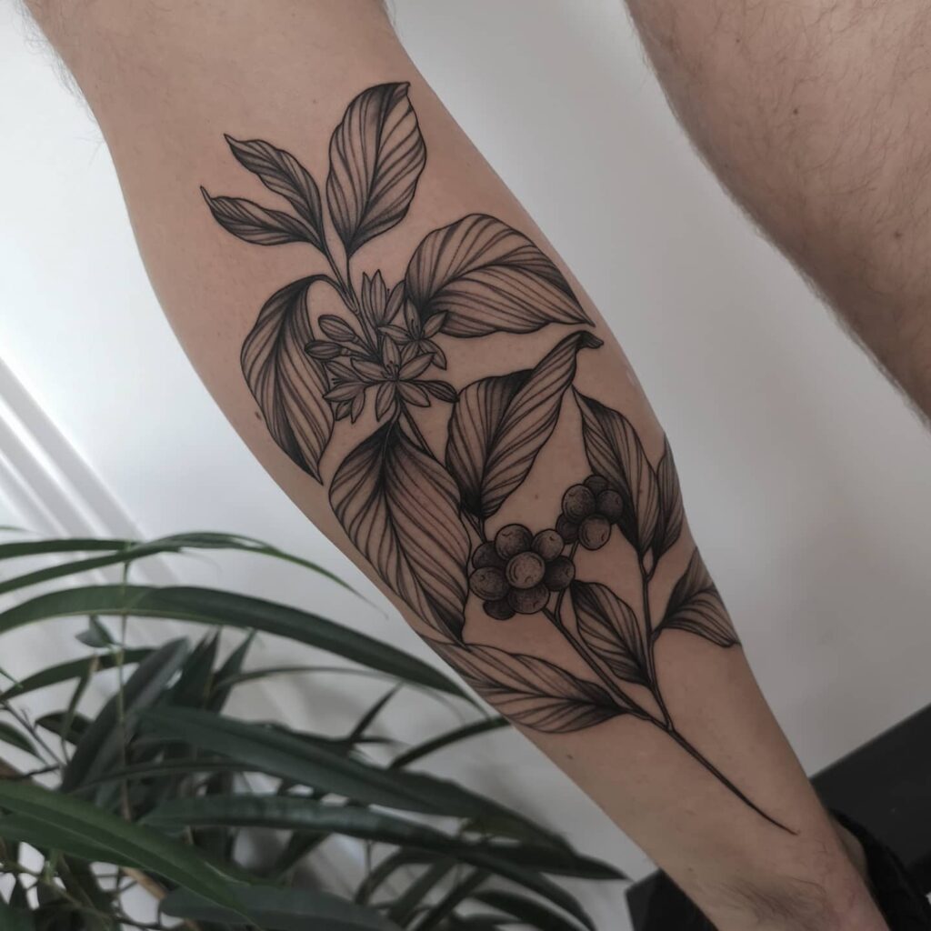 Coffee plant tattoo on back of lower leg for men subtle charm