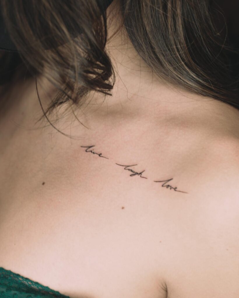 Collar bone live laugh love tattoo female cursive letter
