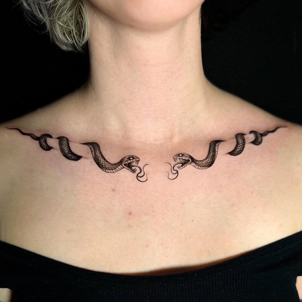 Collarbone artistry with creative dual snake tattoos for a bold statement twin serpent embrace