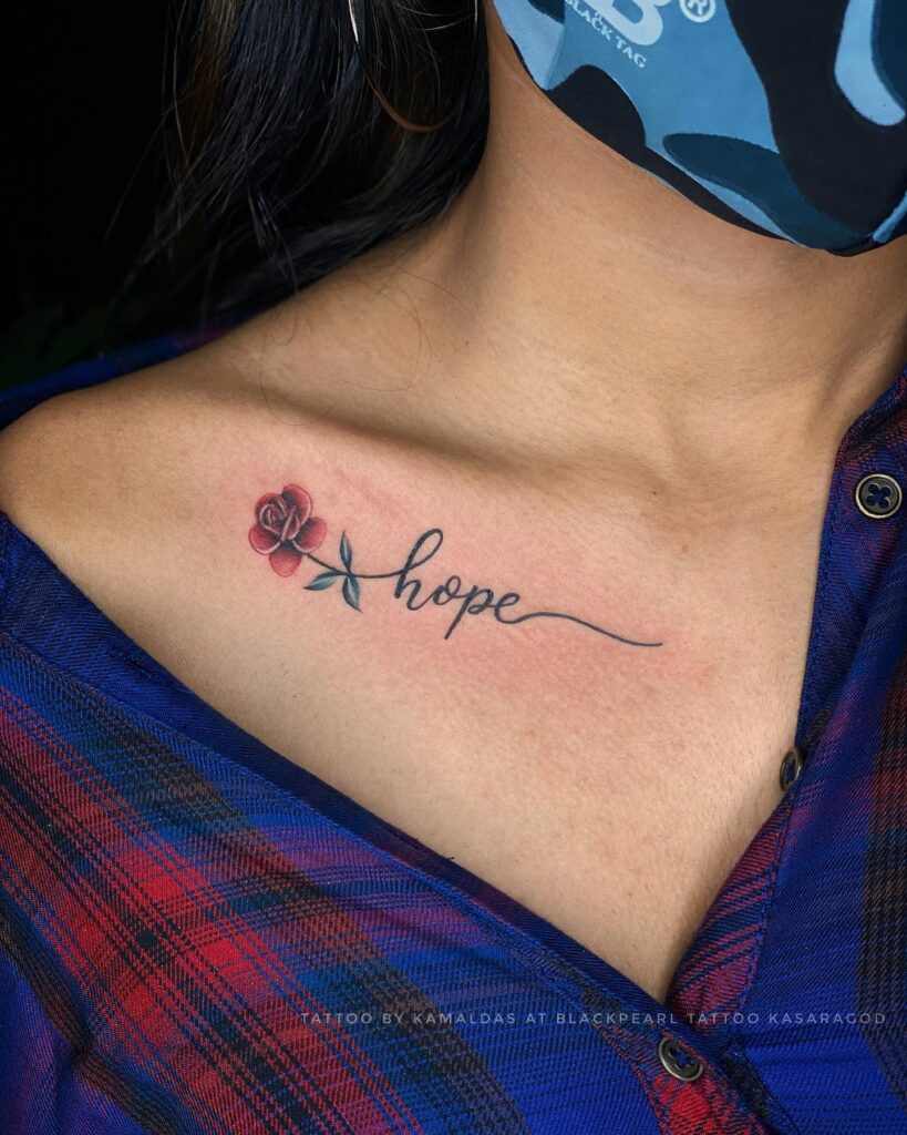 Collarbone tattoo with 'hope' word, small colorful rose, and an artful extension in cursive lettering whispers of hope