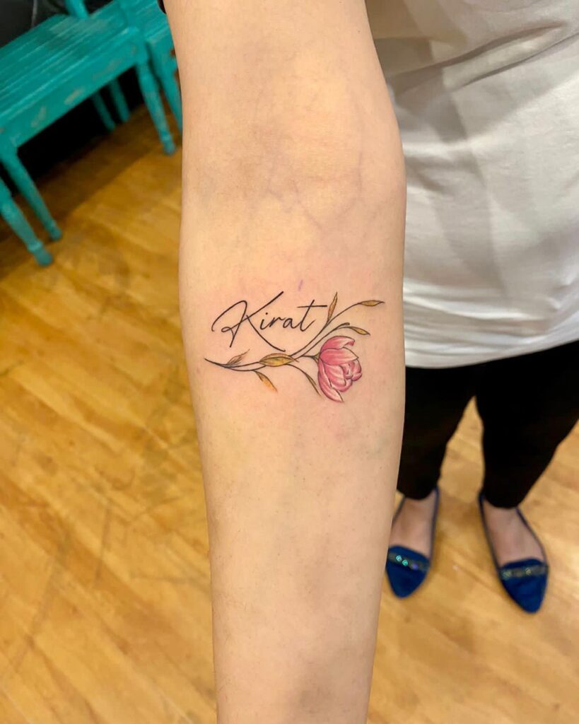 Colorful blooms and words forearm tattoo with kirat lettering