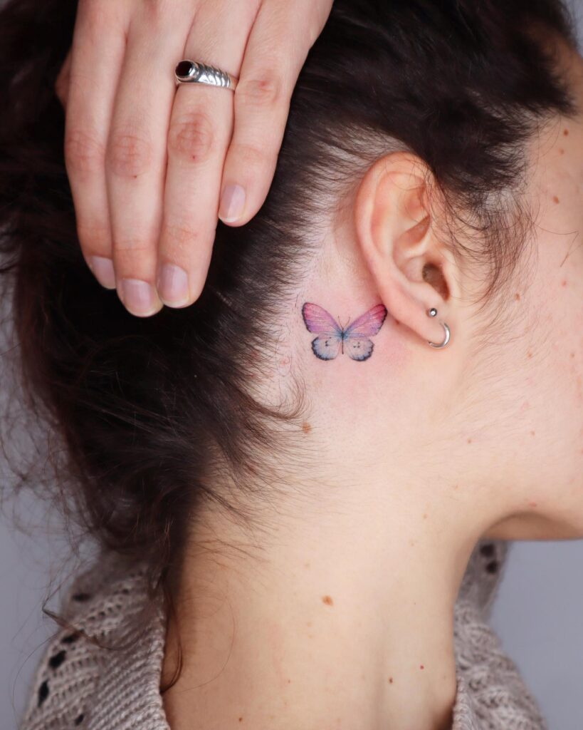 Colorful charm captivating single butterfly tattoo behind the ear
