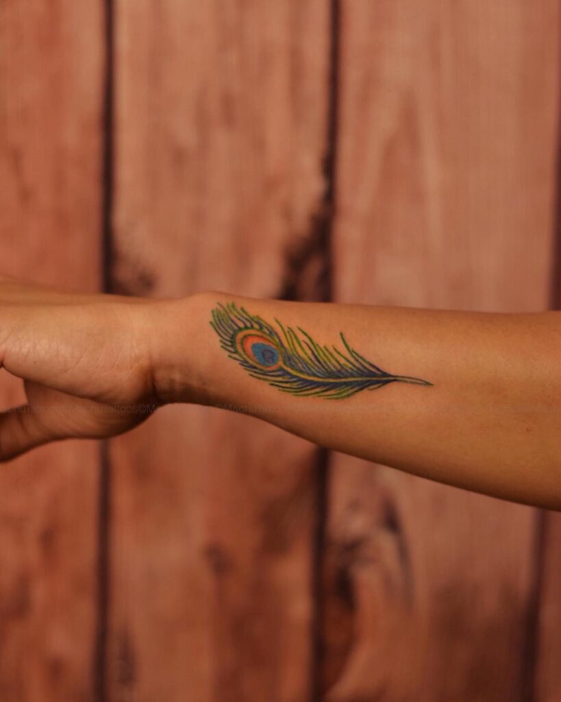 Colorful elegance unique outer wrist peacock feather tattoo