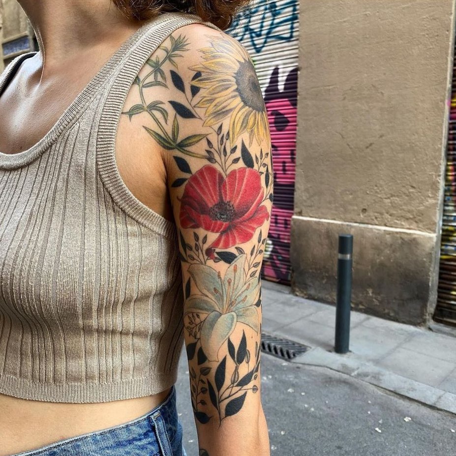 Colorful floral symphony sunflowers and hibiscus in a half sleeve tattoo