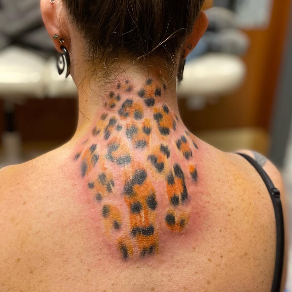 Colorful leopard print tattoo back of the neck for women