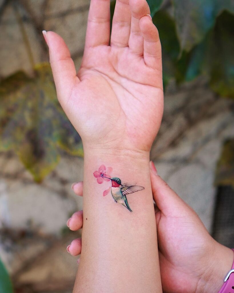 Colorful lil hummingbird on inner wrist classy tattoo for girls