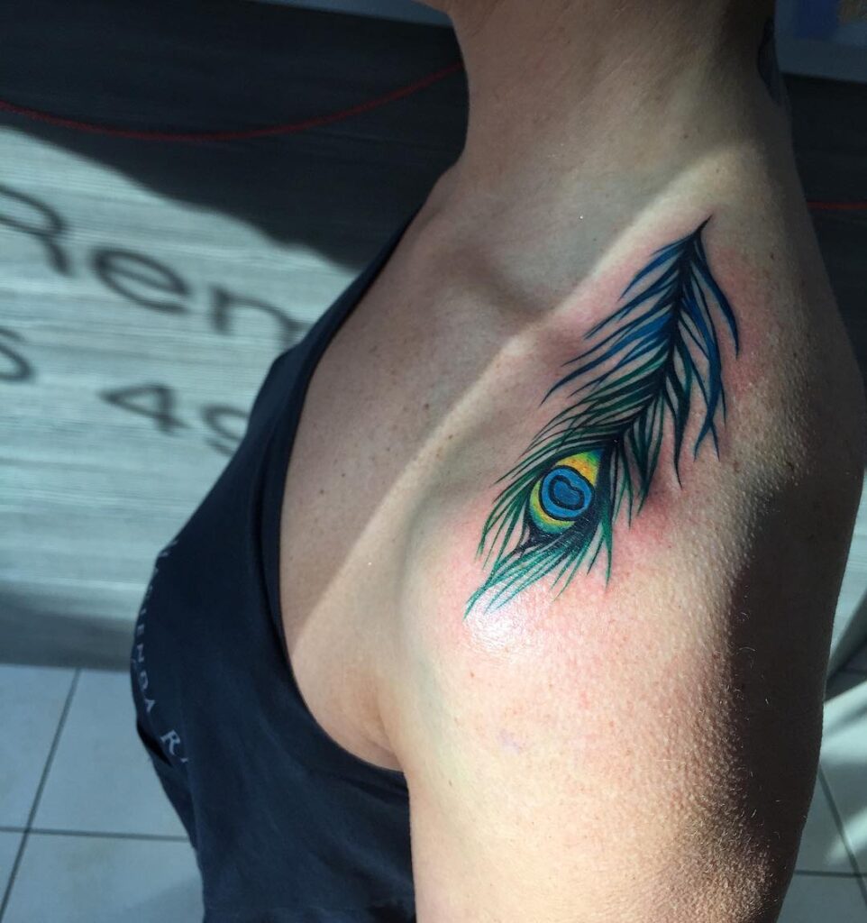 Colorful splendor shoulder peacock feather tattoo bursting with vibrant hues for females