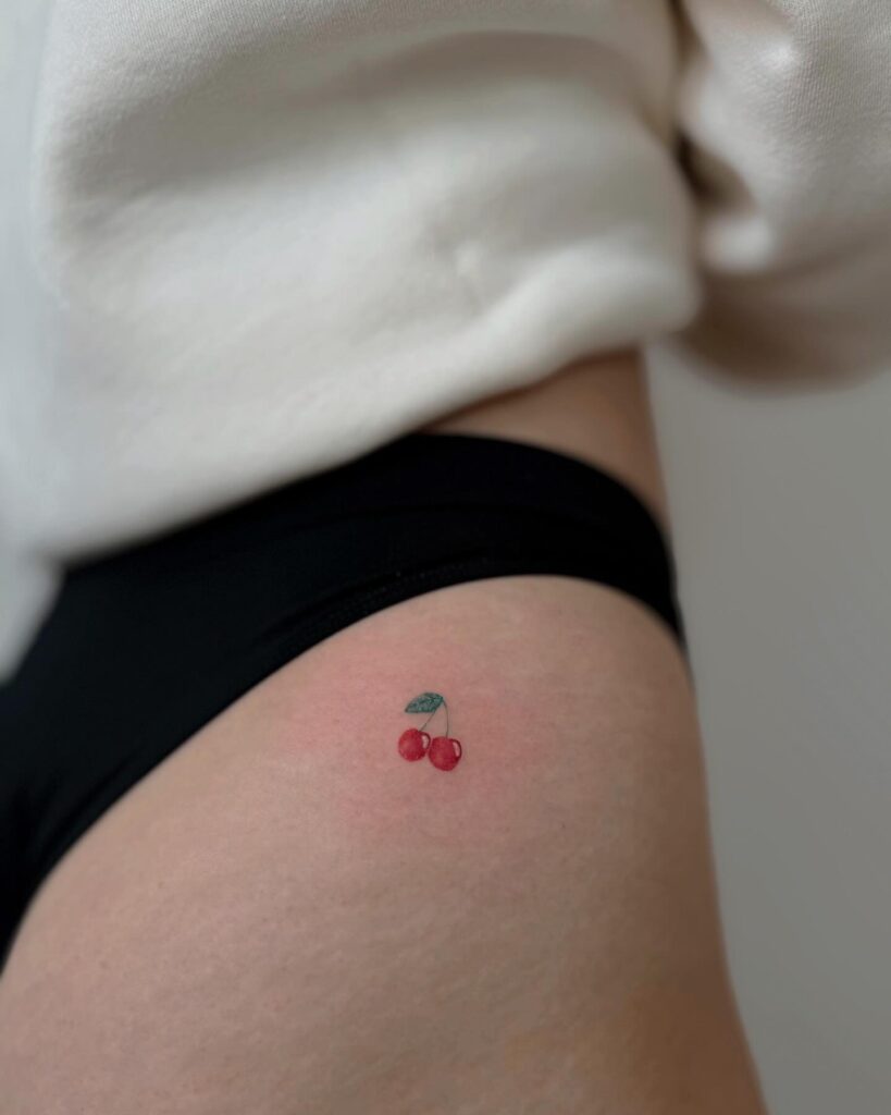 Colorful Tiny Two Cherry Hip Tattoo, a Playful and Juicy Expression: Cherry Delight