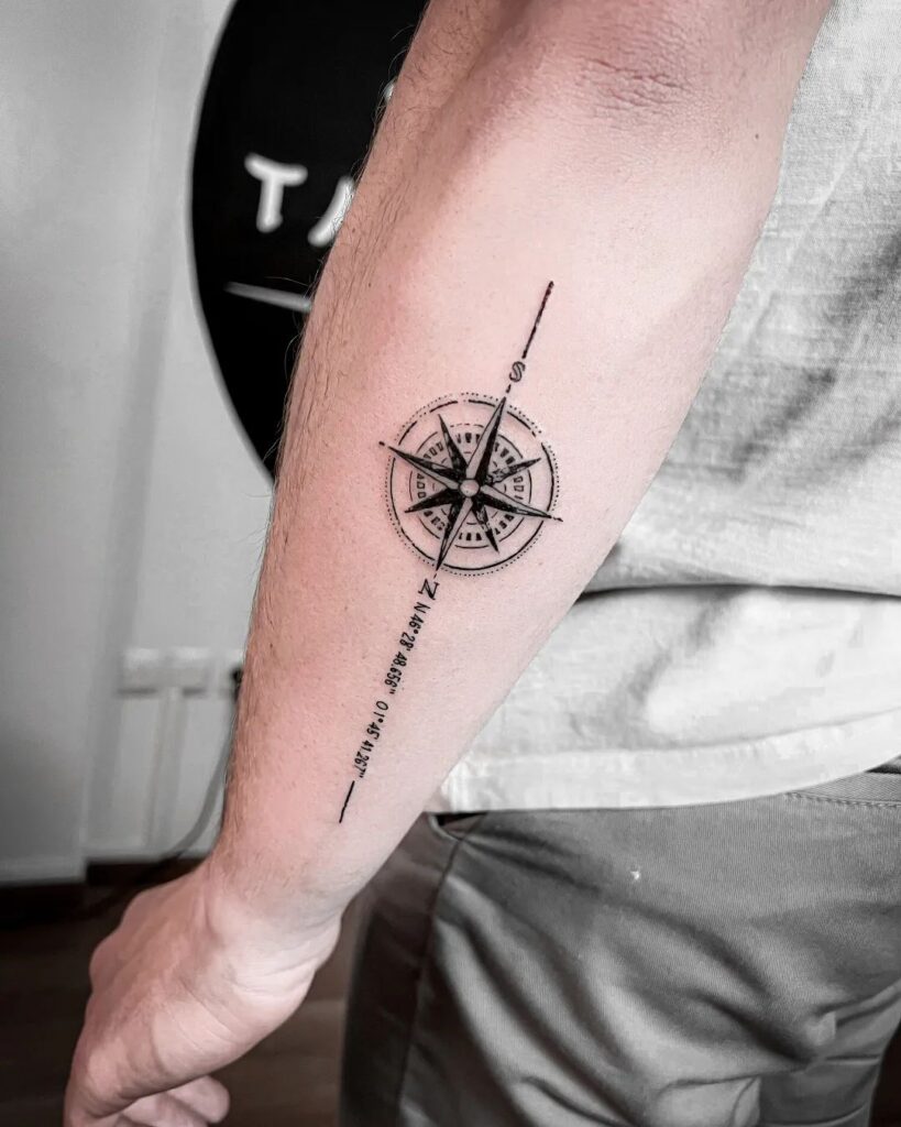 Compass tattoo on the back of the forearm with mentioned coordinates: cosmic coordinates