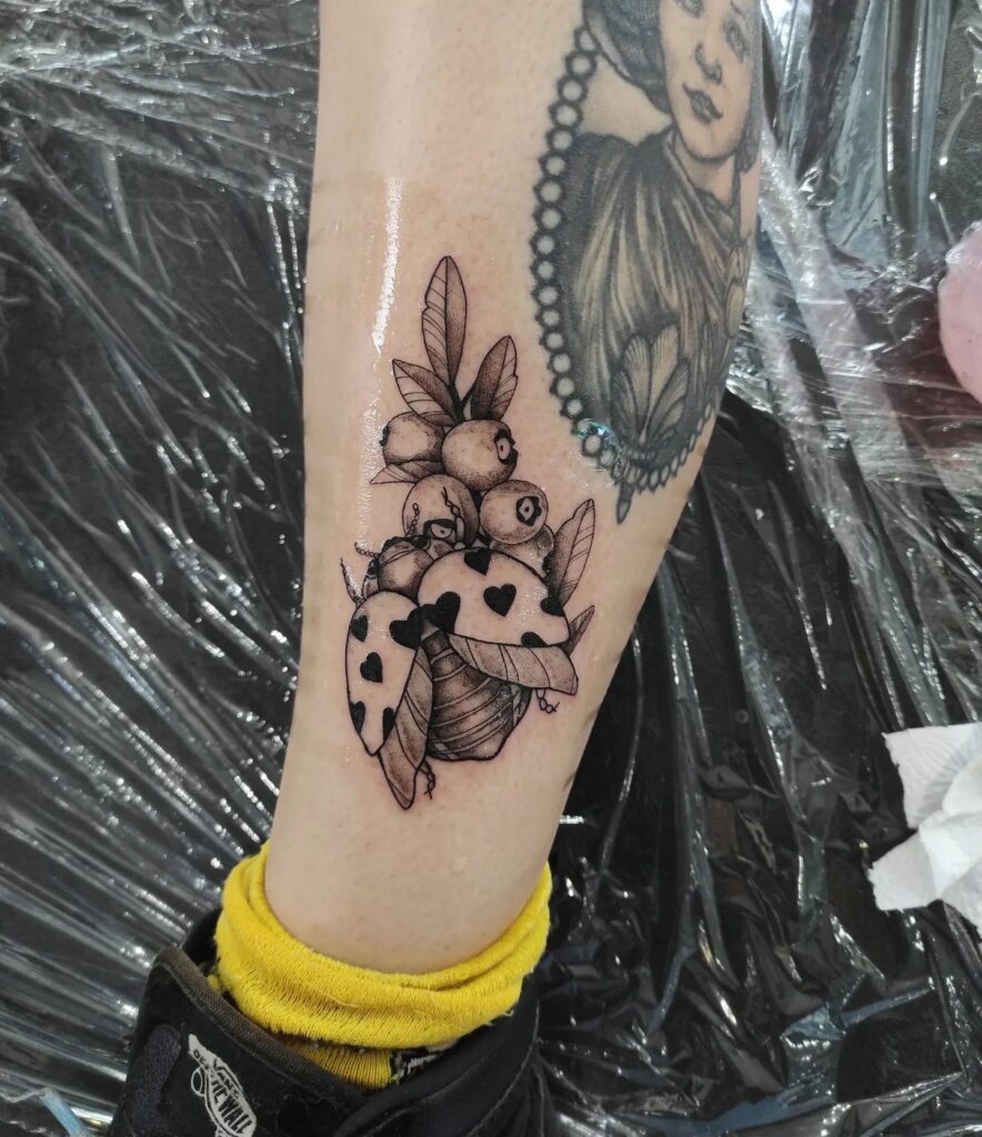Complex Ladybug Tattoo Design With Heart
