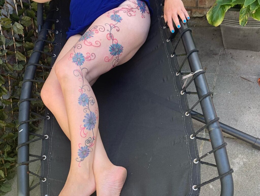 Connecting flowers tattoo design for full leg