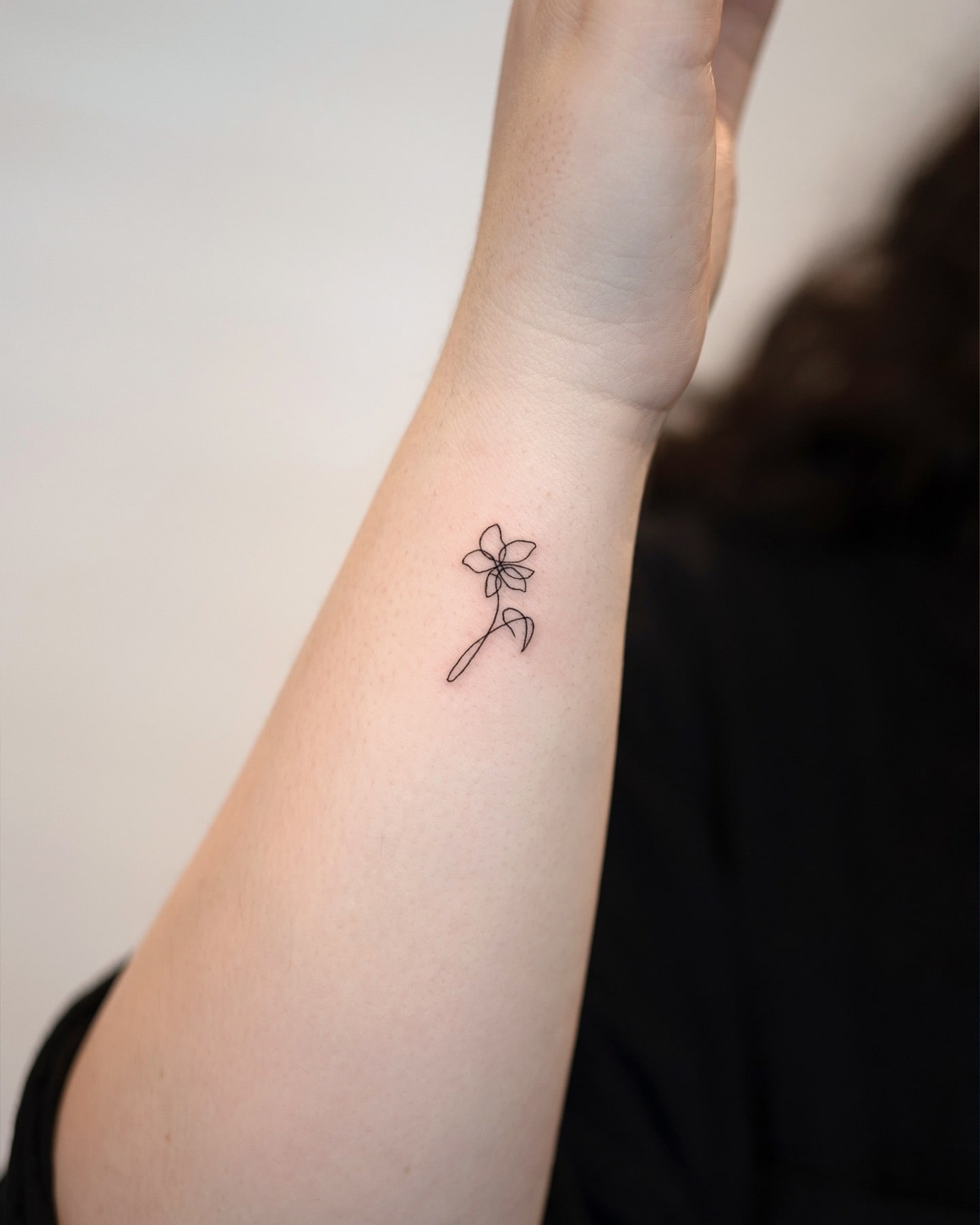 Continuous Line Flower Wrist Tattoo Minimalist and Elegant Design