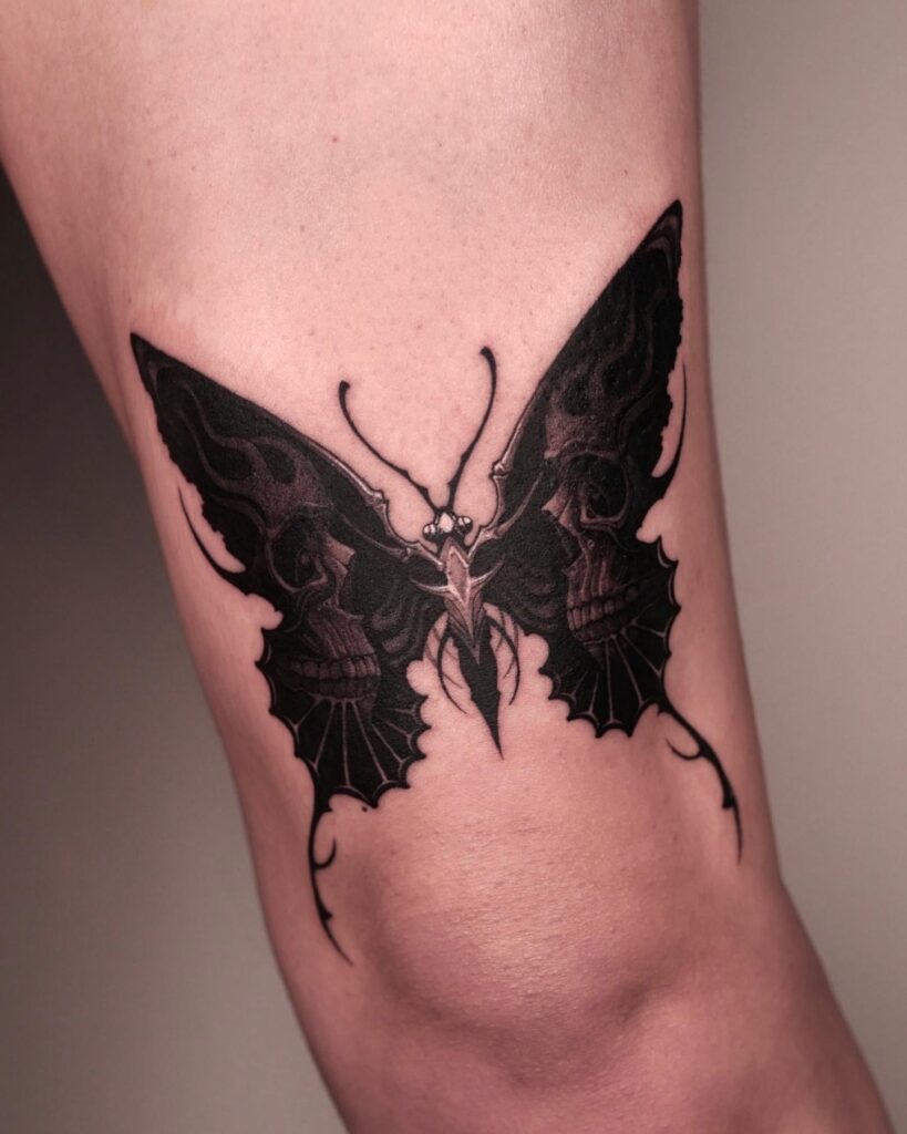 Cool black butterfly skull a unique above-knee tattoo