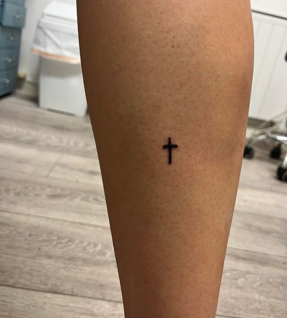 Cool tiny simple cross tattoo on calf female