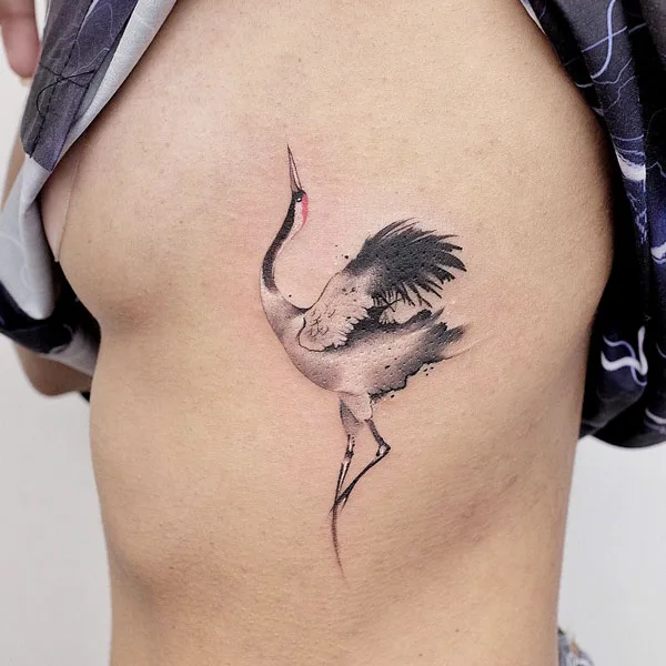 Crane side boob tattoo