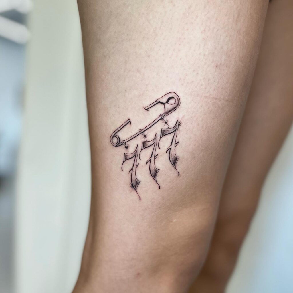 Creative 777 number with safety pin accent, a unique side above the knee tattoo safety pin serenity 