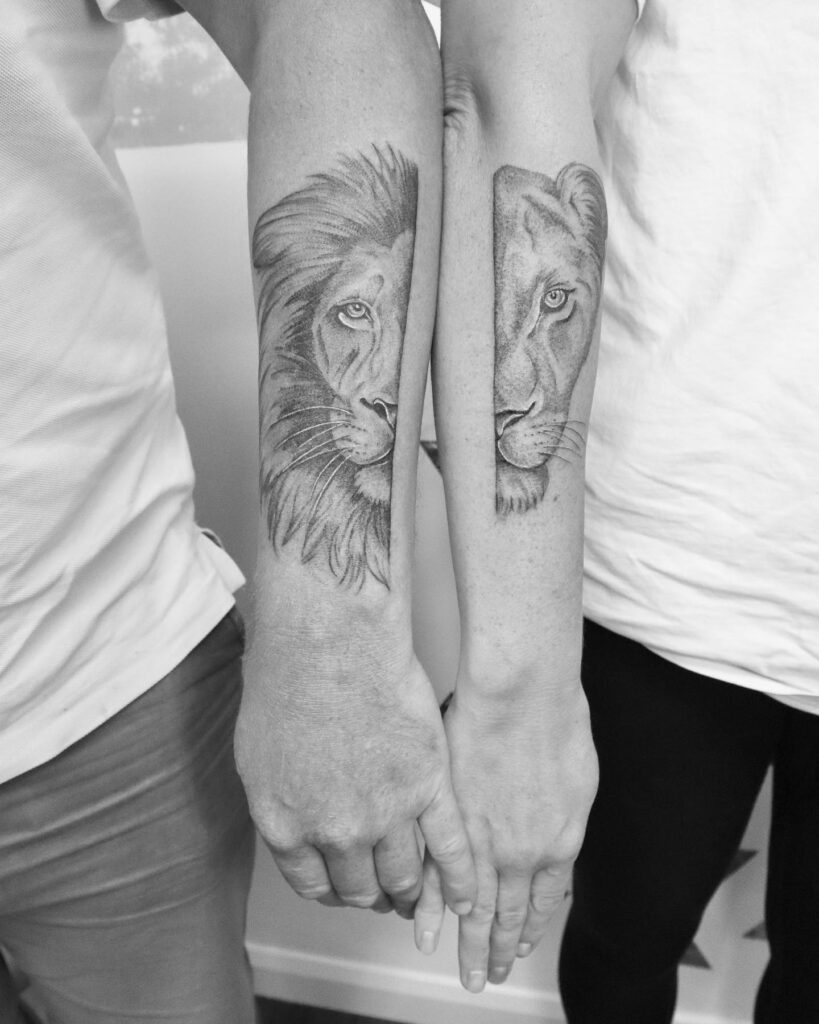 Creative half lion on husband's outer forearm, half lioness on wife's outer forearm: couple’s roar