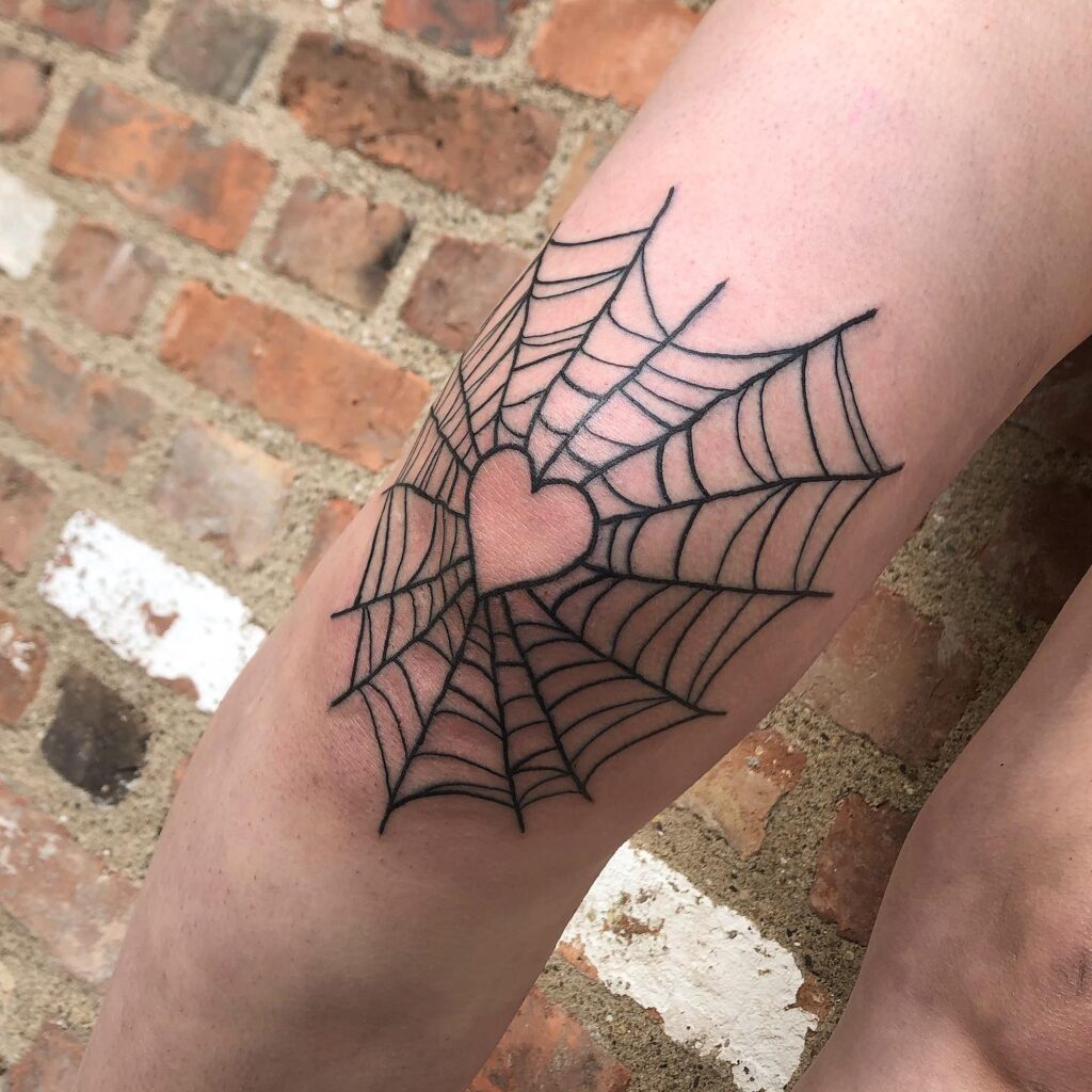 Creative love black outline heart inside the spider web on the knee